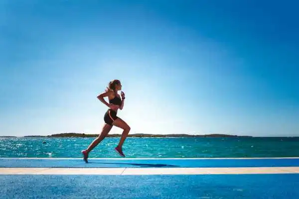 Woman running showing strong leg muscle East Tilbury